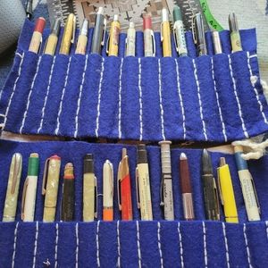 Antique mechanical pencils and a ball point pen with 2 hand-sewn felt rolls